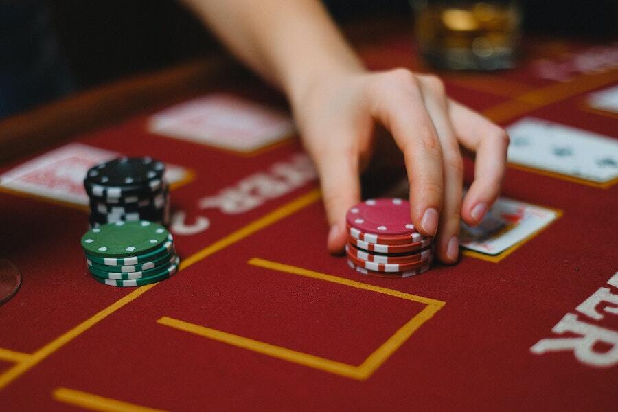 hand placing chips onto a casino table