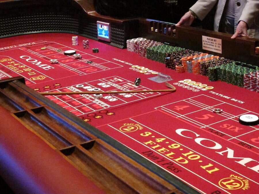 craps table being cleared with a stick