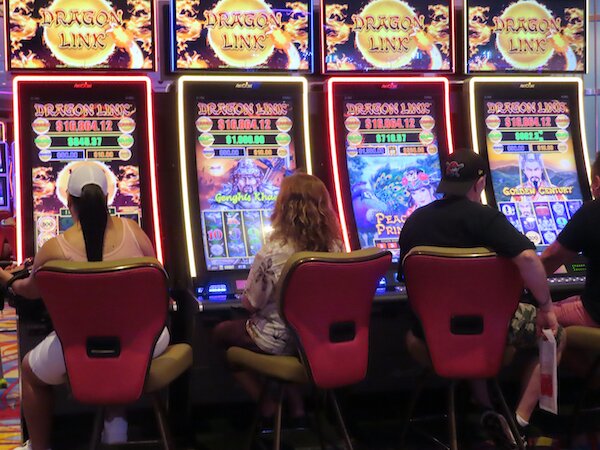Players play pokie machines at a casino