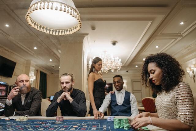 people formally dressed at casino table